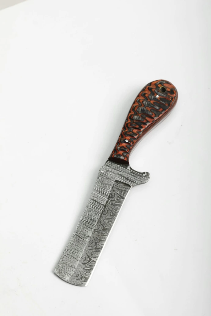 A damascus steel knife with a patterned handle.